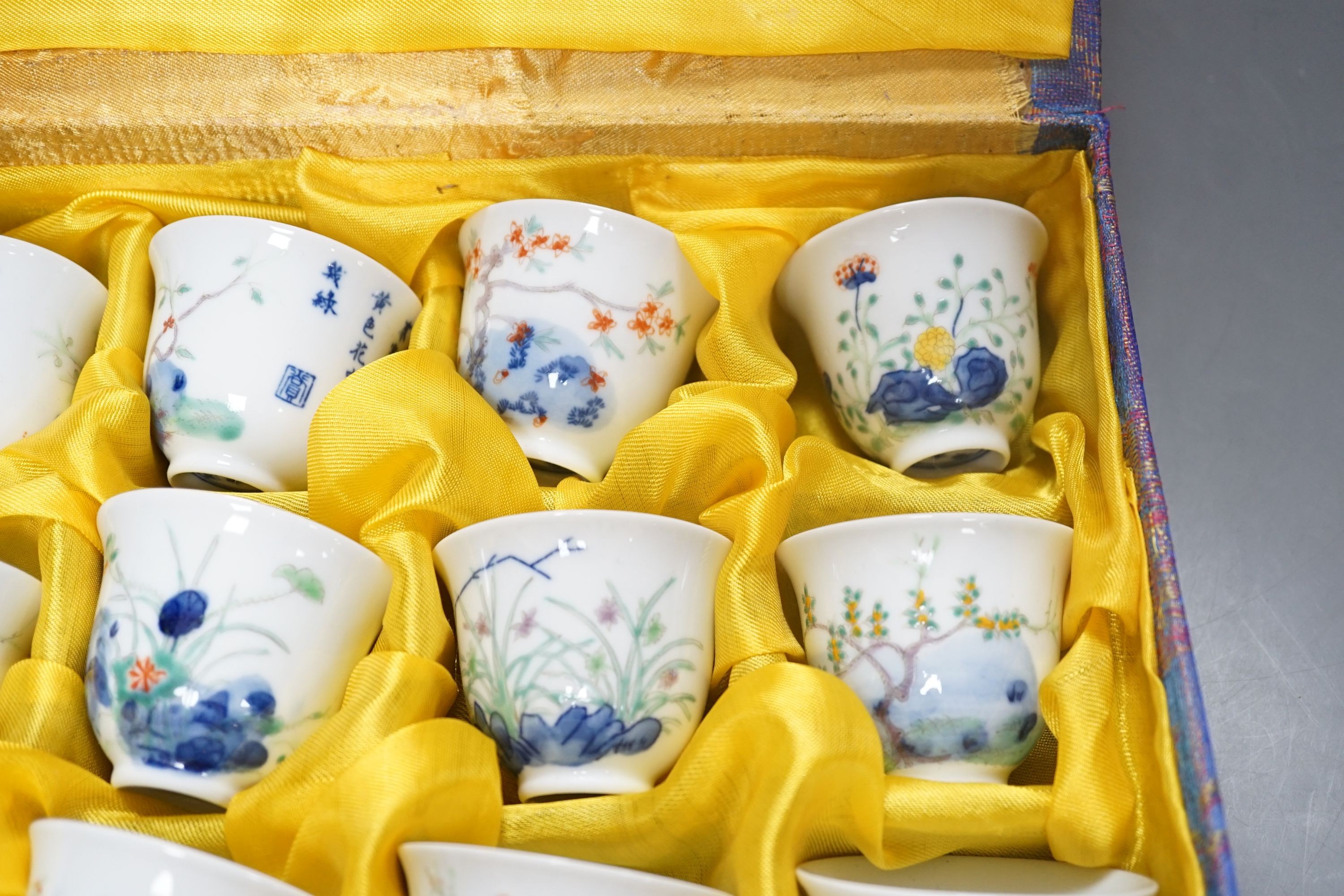 A Chinese boxed set of twelve wucai ‘month’ cups